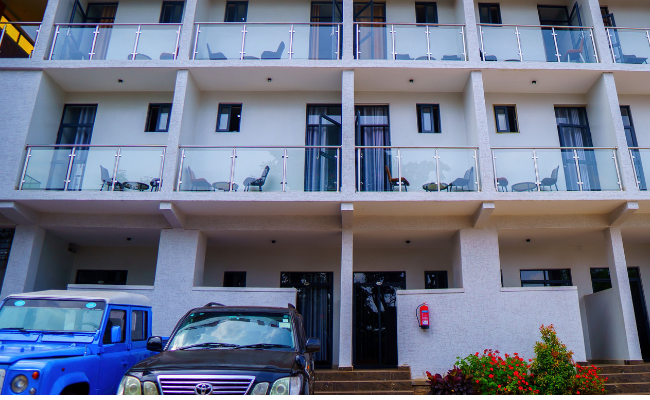 Photo gallery of Fanfare Suites Kigali showing hotel exterior, stylish rooms, and night views for an immersive guest experience