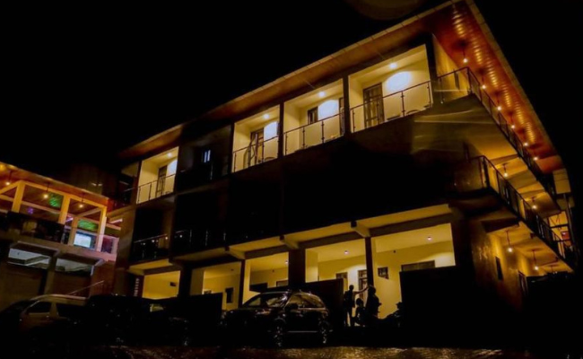 Photo gallery of Fanfare Suites Kigali showing hotel exterior, stylish rooms, and night views for an immersive guest experience