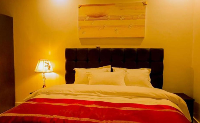 Photo gallery of Fanfare Suites Kigali showing hotel exterior, stylish rooms, and night views for an immersive guest experience